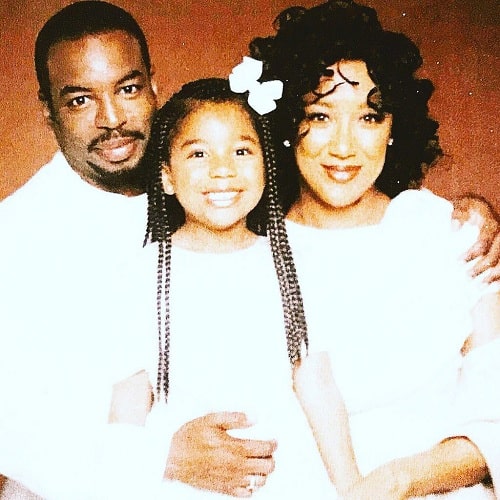 A picture of Michaela Jean Burton with her parents.